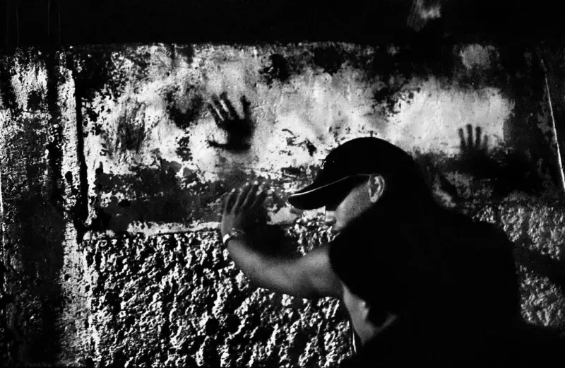 A young man is searched for weapons during a police raid in the slum of Catia. Catia, Caracas, Venezuela. 2004 © Christopher Anderson, Album: Christopher Anderson, Capitolio