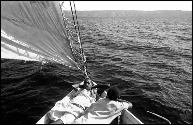 Crew members take a break on the deck as the 'Believe in God' sets sail. Haiti. 2000 © Christopher Anderson, Album: Christopher Anderson, Haiti. Immigrants Trip to America.