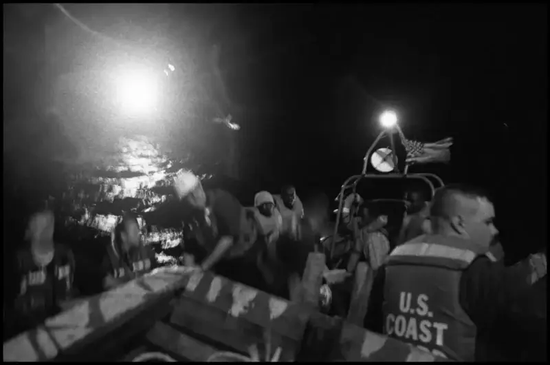 As the 'Believe in God' sinks, the coast-guard boards the boat to rescue its passengers. Haiti © Christopher Anderson, Album: Christopher Anderson, Haiti. Immigrants Trip to America.